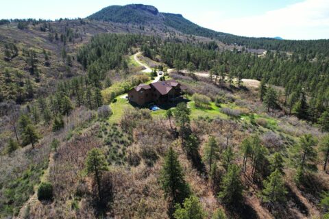 Home on hill after mitigation project with greenery around it